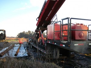 90x30 drill rig setup along bank of wetland
