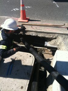 Pulling back second 3-inch conduit through a maze of existing buried infrastructure.